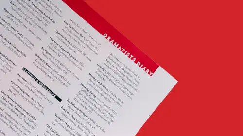 Open page of The Dramatist against a red background