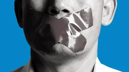Man is silenced with adhesive red tape across his mouth sealed to prevent him from speaking. Freedom Concept.