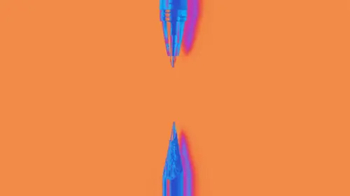 Less is more. A pen on top and pencil on bottom pointing at each other against a orange background